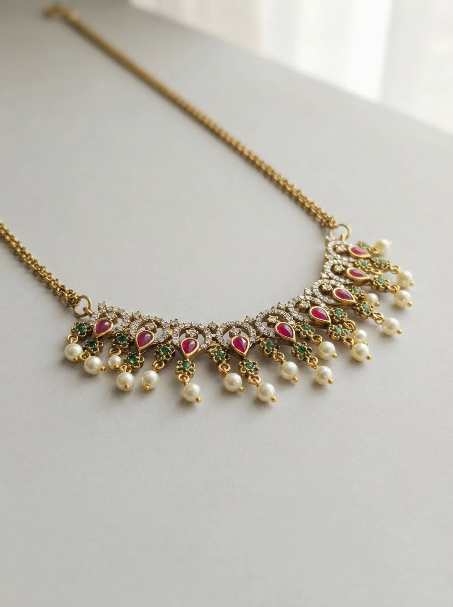 Traditional Kemp stone details, including ruby and emerald accents with pearl drops.