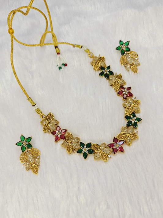 Gold-Plated Floral Motif Necklace And Earring Set Featuring Red, Green, And Clear Stones