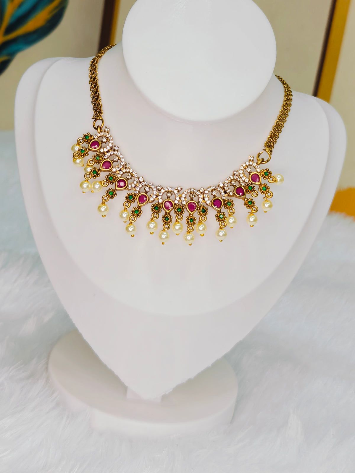Traditional Kemp stone details, including ruby and emerald accents with pearl drops.