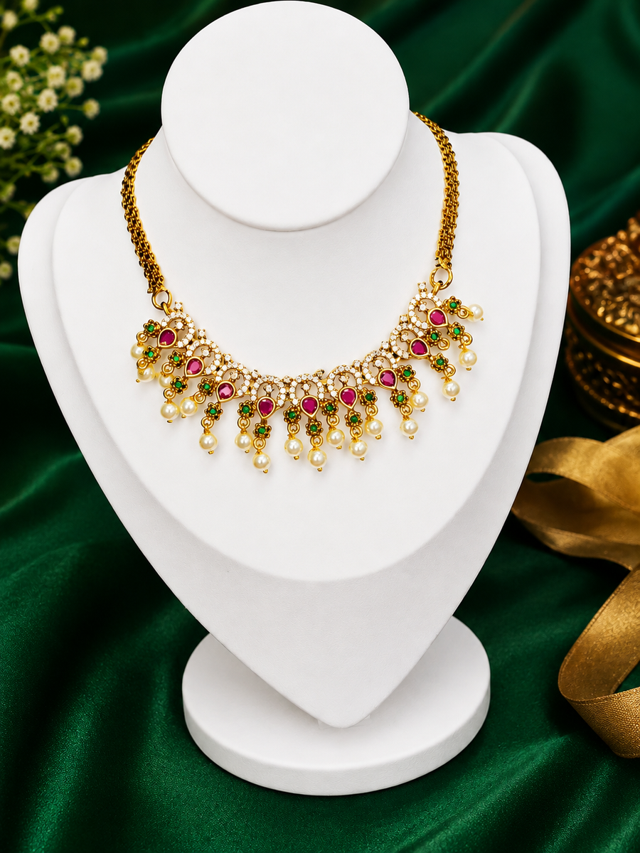 Traditional Kemp stone details, including ruby and emerald accents with pearl drops.