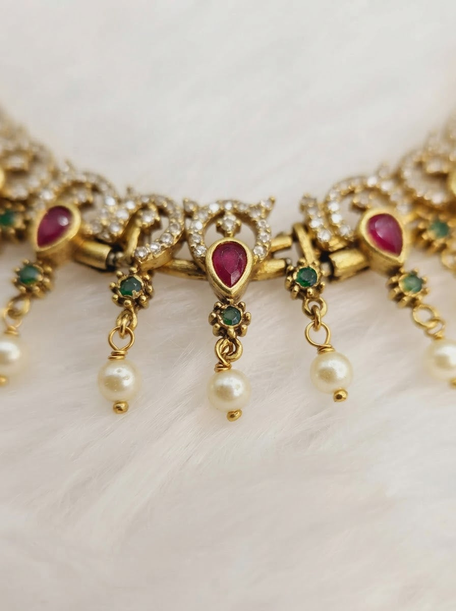 Traditional Kemp stone details, including ruby and emerald accents with pearl drops.